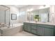 Luxurious bathroom with a soaking tub, a separate glass shower, and double vanity sinks at 681 Beacon Hill Rd # 38, Lillington, NC 27546
