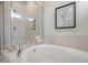 Luxurious bathroom featuring a soaking tub, tiled shower, and neutral color scheme, creating a spa-like retreat at 681 Beacon Hill Rd # 38, Lillington, NC 27546