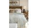 Serene bedroom featuring a textured duvet, decorative pillows, a wooden headboard, and a side table with a stylish lamp at 681 Beacon Hill Rd # 38, Lillington, NC 27546