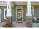Inviting front entrance with stone accents, bright lighting, and a charming rocking chair on the spacious front porch at 681 Beacon Hill Rd # 38, Lillington, NC 27546
