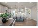 Open-concept kitchen featuring white cabinets, stainless steel appliances, and an island with bar seating at 681 Beacon Hill Rd # 38, Lillington, NC 27546