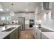 Modern kitchen featuring white cabinets, stainless steel appliances, a kitchen island, and hardwood floors at 681 Beacon Hill Rd # 38, Lillington, NC 27546