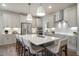 Gourmet kitchen featuring a large center island, stainless steel appliances, and pendant lighting at 681 Beacon Hill Rd # 38, Lillington, NC 27546
