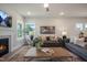 Cozy living room features a fireplace, plush sofas, a stylish coffee table, and a ceiling fan at 681 Beacon Hill Rd # 38, Lillington, NC 27546