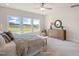 Bright main bedroom with large windows, dresser, and cozy chair at 681 Beacon Hill Rd # 38, Lillington, NC 27546