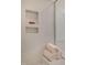 Detailed view of a shower with tiled walls, shower shelf and neatly folded towels at 681 Beacon Hill Rd # 38, Lillington, NC 27546