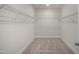 Walk-in closet featuring wire shelving, carpeted floors, and ample storage space for an organized wardrobe at 681 Beacon Hill Rd # 38, Lillington, NC 27546