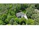 Aerial view of a stunning home nestled among lush trees, showcasing its expansive layout and picturesque surroundings at 7400 Portpatrick Ct, Wake Forest, NC 27587