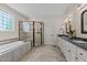Bathroom featuring a shower, tub, and double sink at 7400 Portpatrick Ct, Wake Forest, NC 27587