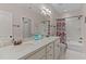 Spacious bathroom features a double vanity, large mirror, and shower with colorful curtain at 7400 Portpatrick Ct, Wake Forest, NC 27587