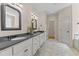 Bathroom with a double sink vanity with white cabinets and granite countertop at 7400 Portpatrick Ct, Wake Forest, NC 27587