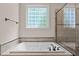 Bathroom featuring a relaxing soaking tub next to a separate shower at 7400 Portpatrick Ct, Wake Forest, NC 27587