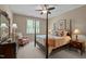 Bedroom features a four-poster bed, floral accent chair, and coordinated side tables at 7400 Portpatrick Ct, Wake Forest, NC 27587