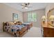 Bedroom featuring two twin beds, window, ceiling fan and wooden dresser at 7400 Portpatrick Ct, Wake Forest, NC 27587
