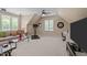 Bonus room with large windows, sectional couch, computer desk, TV, and exercise equipment at 7400 Portpatrick Ct, Wake Forest, NC 27587