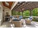 Inviting covered deck with wood-beam pergola, ceiling fan and comfortable seating area, ideal for outdoor relaxation and entertaining at 7400 Portpatrick Ct, Wake Forest, NC 27587