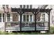 Outdoor deck area features comfortable seating and a dark wooden pergola offering shaded relaxation at 7400 Portpatrick Ct, Wake Forest, NC 27587