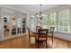 Bright dining room with hardwood floors, chandelier, a wood table, and views of the backyard at 7400 Portpatrick Ct, Wake Forest, NC 27587
