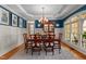 Formal dining room with wainscoting, chandelier, and elegant furniture at 7400 Portpatrick Ct, Wake Forest, NC 27587