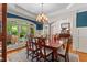 Dining room with large windows and an exquisite chandelier at 7400 Portpatrick Ct, Wake Forest, NC 27587