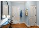 Bright entryway featuring coat rack, wooden floors, and a decorative table with lamp at 7400 Portpatrick Ct, Wake Forest, NC 27587