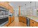 Spacious kitchen with stainless steel appliances, granite countertops, wood floors, and a breakfast area at 7400 Portpatrick Ct, Wake Forest, NC 27587