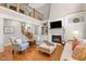 Spacious living room with fireplace, second floor balcony, and bright lighting at 7400 Portpatrick Ct, Wake Forest, NC 27587