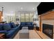 Comfortable living room with fireplace, TV, and large windows at 7400 Portpatrick Ct, Wake Forest, NC 27587