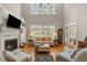 Bright living room with fireplace, built-in shelving, and large windows at 7400 Portpatrick Ct, Wake Forest, NC 27587