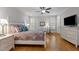 Comfortable main bedroom with hardwood floors and a large TV at 7400 Portpatrick Ct, Wake Forest, NC 27587