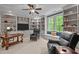 Office with built-in bookshelves, a ceiling fan, a window seat, and two leather chairs at 7400 Portpatrick Ct, Wake Forest, NC 27587