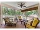 Screened-in porch with a ceiling fan and outdoor furniture for relaxing and entertaining at 7400 Portpatrick Ct, Wake Forest, NC 27587