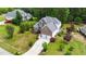 Aerial view showcases a charming two-story home with a well-manicured lawn and mature trees at 7405 Pine Summit Dr, Fuquay Varina, NC 27526