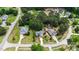 Aerial shot of homes in a wooded neighborhood with lush green lawns and mature trees at 7405 Pine Summit Dr, Fuquay Varina, NC 27526