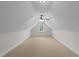 Finished attic featuring carpet, walls, ceiling fan, and a window with natural light at 7405 Pine Summit Dr, Fuquay Varina, NC 27526