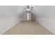 Spacious finished attic featuring carpet, walls, and a ceiling fan with natural light at 7405 Pine Summit Dr, Fuquay Varina, NC 27526
