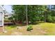 The home's lush backyard features mature trees, a wooden deck, and access to the screened-in back porch at 7405 Pine Summit Dr, Fuquay Varina, NC 27526