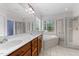 Luxurious bathroom with double vanity, soaking tub, and glass-enclosed shower for a spa-like experience at 7405 Pine Summit Dr, Fuquay Varina, NC 27526