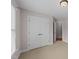 Bedroom with carpet, neutral walls, and closet doors under a traditional light fixture at 7405 Pine Summit Dr, Fuquay Varina, NC 27526