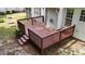 A wooden deck with railings and steps leading down to the yard at 7405 Pine Summit Dr, Fuquay Varina, NC 27526