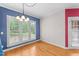 Dining room with hardwood floors and large windows overlooking the backyard at 7405 Pine Summit Dr, Fuquay Varina, NC 27526