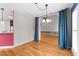 Bright dining room featuring hardwood floors, modern lighting, and an open layout perfect for entertaining at 7405 Pine Summit Dr, Fuquay Varina, NC 27526
