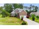 Charming two-story brick home with a two-car garage, lush green lawn, and well-maintained landscaping at 7405 Pine Summit Dr, Fuquay Varina, NC 27526