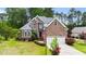 Charming brick two-story home featuring an attached two-car garage and beautifully landscaped front yard at 7405 Pine Summit Dr, Fuquay Varina, NC 27526