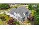 An aerial view of the home's rear exterior with a screened-in porch, deck, and lush landscaping at 7405 Pine Summit Dr, Fuquay Varina, NC 27526