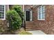 Close-up shot of a home's beautiful front door, brick steps, with landscaping at 7405 Pine Summit Dr, Fuquay Varina, NC 27526