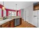 Functional kitchen featuring wood cabinets, stainless steel dishwasher, and efficient food preparation at 7405 Pine Summit Dr, Fuquay Varina, NC 27526