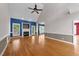 Open-concept living room boasts hardwood floors, fireplace, and large windows for lots of light at 7405 Pine Summit Dr, Fuquay Varina, NC 27526