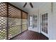 Outdoor porch with ceiling fan, wood floors and a lattice-style privacy screen at 7405 Pine Summit Dr, Fuquay Varina, NC 27526