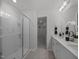 Modern bathroom featuring a glass shower, double vanity, and bright lighting at 741 Deschutes Dr, Garner, NC 27529
